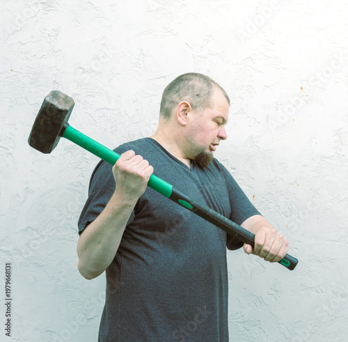 Wallpaper Mural Man grips heavy hammer with focused intensity Torontodigital.ca