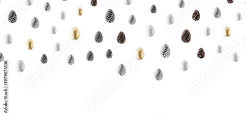 Fotografía Decorative Easter eggs in white, gold, and textured patterns floating on white background