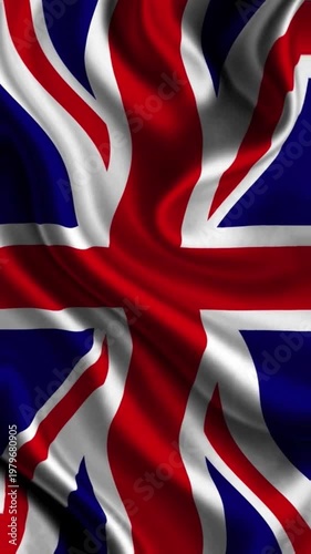 Wavy silk fabric texture of the United Kingdom Union Jack flag with realistic light reflections.