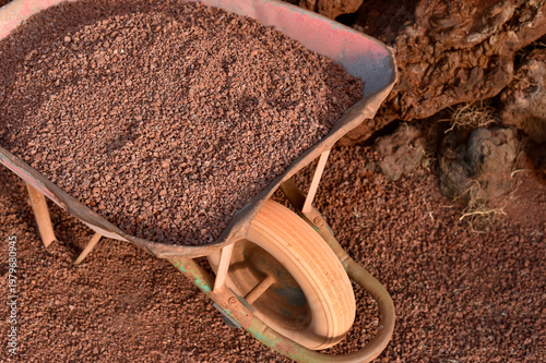 Photos Metal wheelbarrow filled with red volcanic gravel on Lanzarote