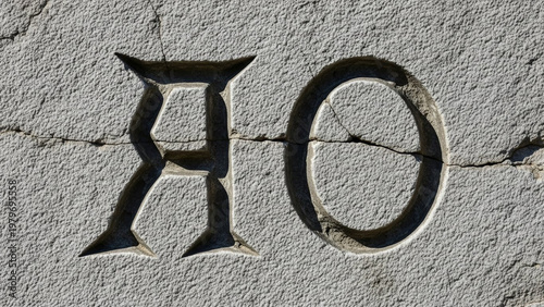 Stone carving of 'ro' letters: chiseled, gray rock texture, shadowed, ancient style