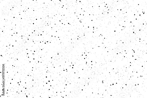 A minimalist arrangement of tiny black ink dots and splatters randomly dispersed across a bright white surface
