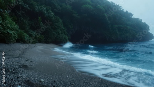 Misty beach scene with dark green cliffs and ocean waves