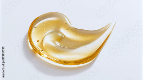 Golden honey or cosmetic gel smear with air bubbles creating a translucent texture on a white background