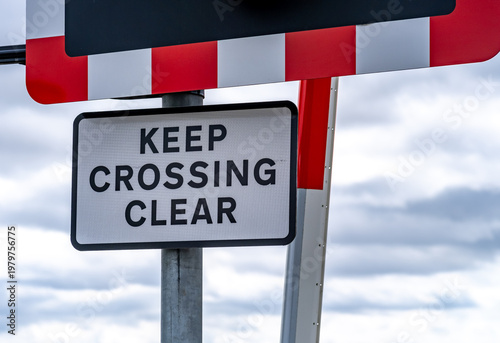 Fotografie Close and selective focus of a railway Keep Crossing Clear sign