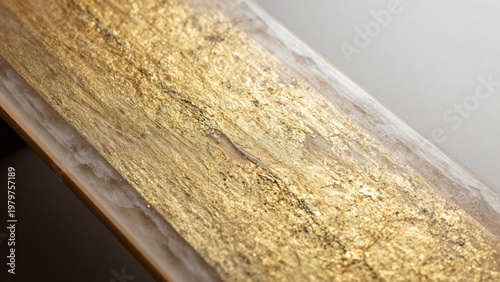 Close-Up of a Luxurious Gold Leaf Texture on a Smooth Wooden Surface