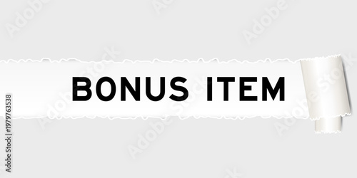 Ripped gray paper background that have word bonus item under torn part
