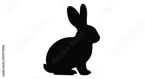 A simple black silhouette of a seated rabbit facing left silhouette