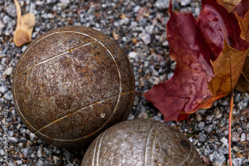 two boule balls in gravel path