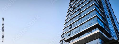 Eco-friendly building in modern city. Sustainable glass office building with trees for reducing CO2. Green architecture. Building with green environment. Sustainability corporate. Net zero emissions.
