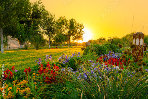 Scenic early morning sunrise view over a blooming flower garden and green park near the historical Khoja Ahmed Yasawi (Қожа Ахмет Ясауи) complex, Turkestan, Kazakhstan