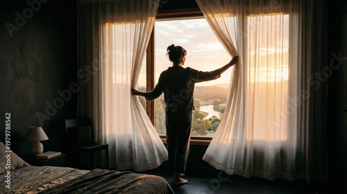 Woman opening bedroom curtains letting sunlight in peaceful morning scene