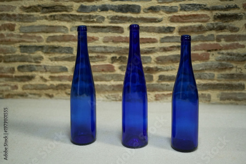 Three blue glass bottles minimal stilllife rustic interior design composition