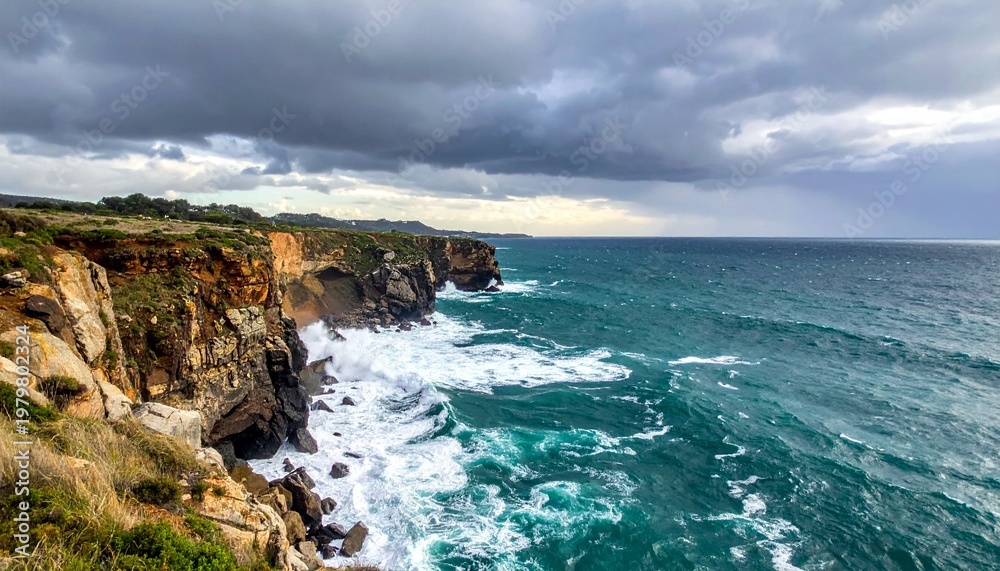 Fototapeta premium Waves crash against rugged cliffside on a stormy day at ocean