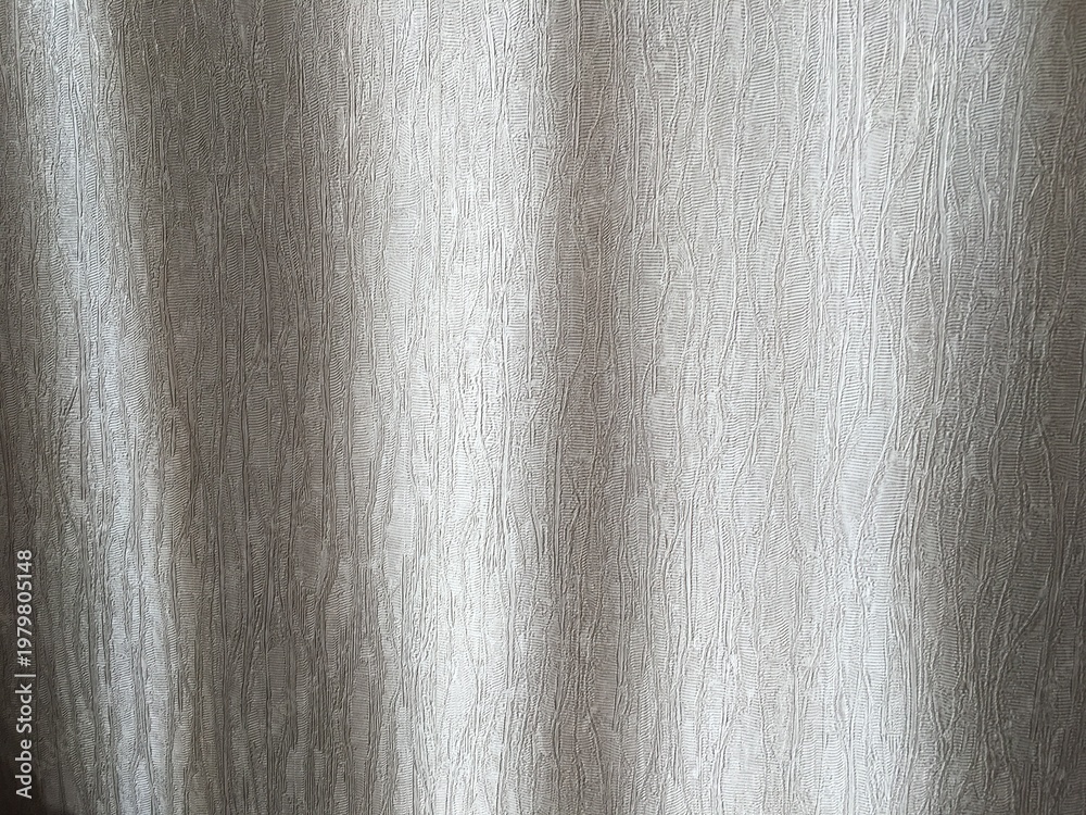 Fototapeta premium Light shines through flowing fabric in a bright room during daytime hours