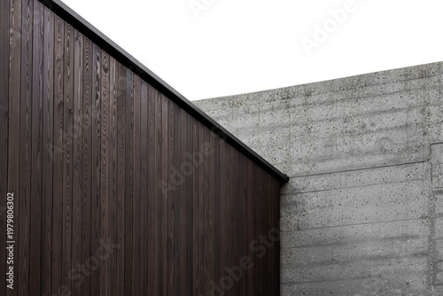 A dark wood wall and a raw concrete wall. Minimalistic architecture. Contrasting building materials.