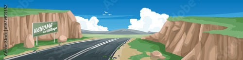Horizontal or landscape view of asphalt road on hills to village. Sits on a hillside with small cliffs on both sides with Welcome Sign board. Background of road on meadow and mountain under the sky.