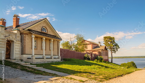 A street with wooden houses of an ancient city on the high bank of the Volga River