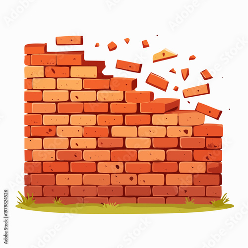 Cracked brick wall with crumbling bricks and grass at the bottom