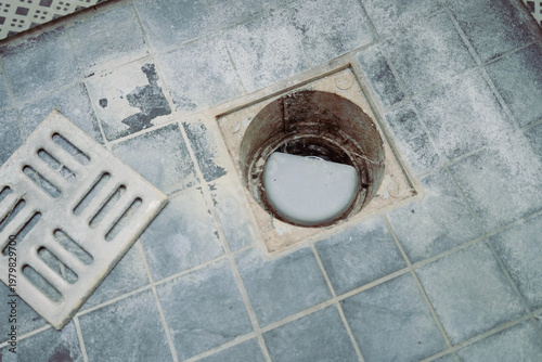 Εκτύπωση καμβά Open bathroom floor drain with visible lime scale and mineral buildup on gray ti