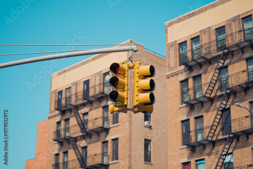 Traffic light signal in the city. American style yellow traffic light in New York City. Traffic in the city. Background with classical buildings.