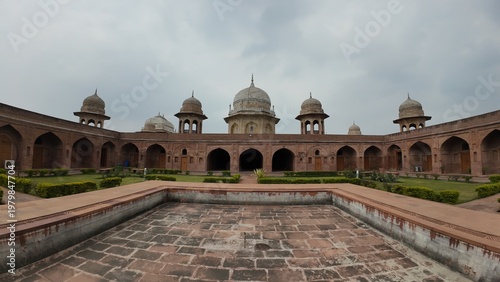 Symmetrical View of the Historic Inner Courtyard and Domes at Sheikh Chilli Tomb in Kurukshetra under a Cloudy Sky