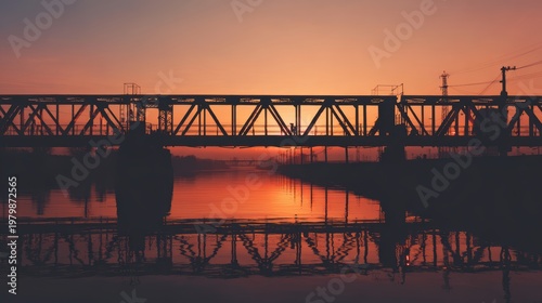 Sunset Reflection Over Bridge with Calm Water and Warm Sky Colors