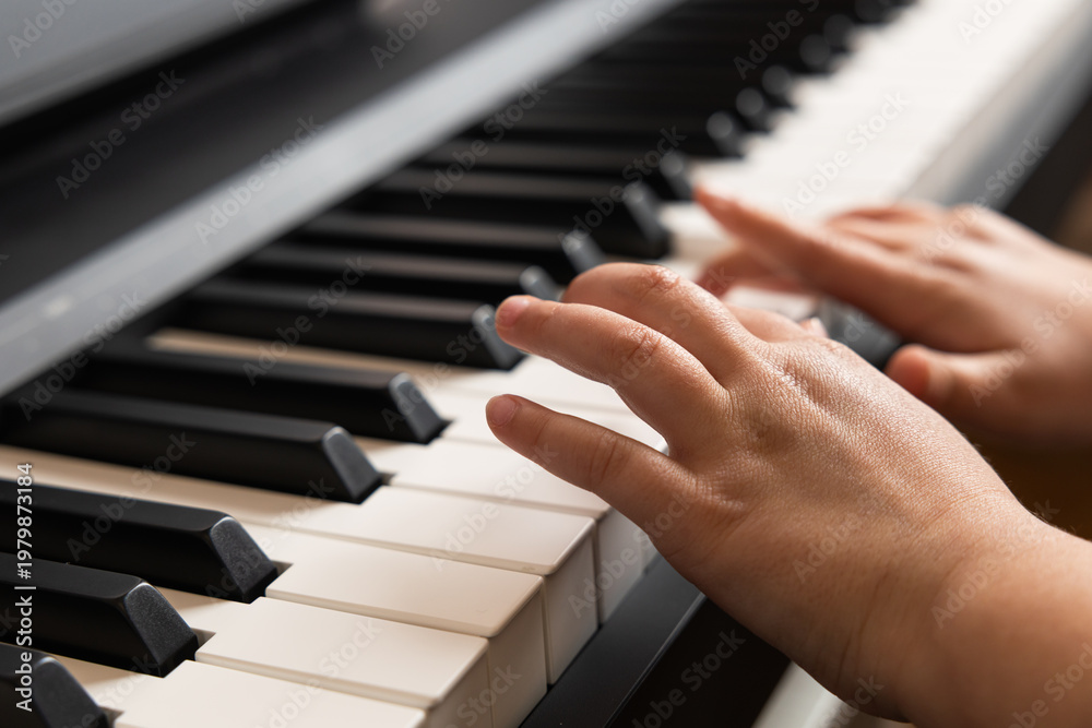 Obraz premium Child hands playing on modern digital piano keyboard