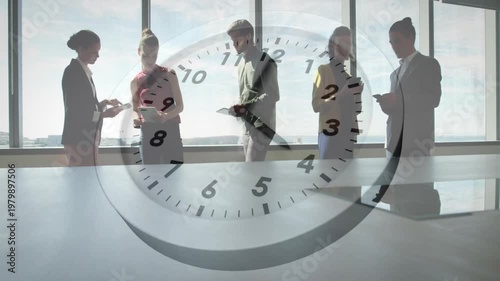 Animation of clock moving over diverse colleagues discussing work in office