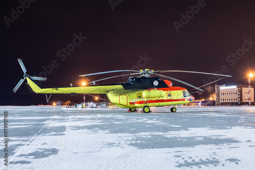 Medical helicopter on winter airport at night