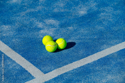 Three Padel Balls on Blue Court The Concept of Racket Sports.