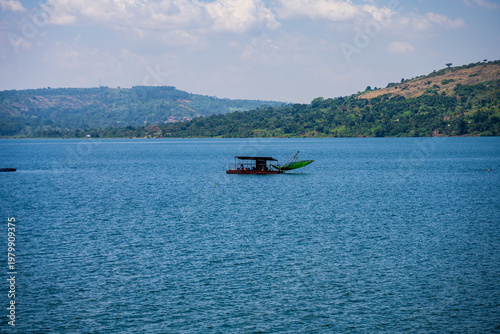 Fishing boat on Lake Victoria near Entebbe with wooded hills in the background