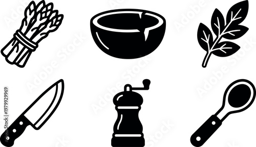 Black and white kitchen utensils knife spice grinder spoon bowl asparagus and herb leaves