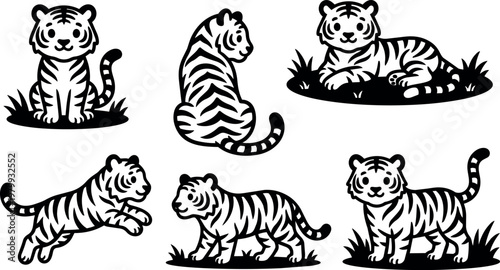 Cute tiger cubs in various poses on grass