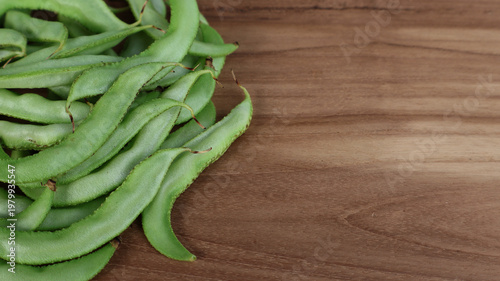 Fresh Green Hyacinth Beans on Wooden Table with Copy Space