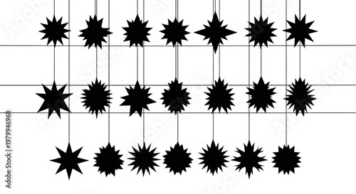 Black starburst decorations hanging from strings on a white background for festive events and celebrations