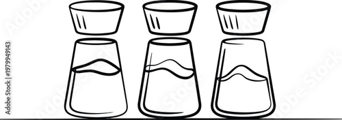 Three glass spice shakers with lids arranged in a row for kitchen seasoning and cooking tasks