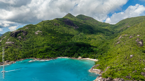 A secluded cove with beach surrounded by dense tropical forest. Anse Major. Seychelles, Mahe.
