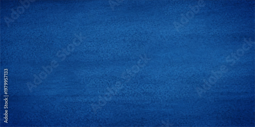 A closeup of dark blue denim fabric texture with a rough cotton textile pattern creates a textured clothing material backdrop for fashion design and wallpaper