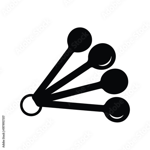 A set of four black measuring spoons connected by a ring, culinary tools