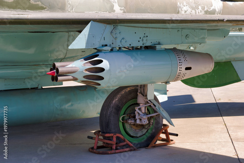Bilde på lerret Military aircraft with missile mounted on wing at an airbase during daytime near