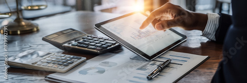 Tax consultant analyzes financial data using a tablet in a modern office