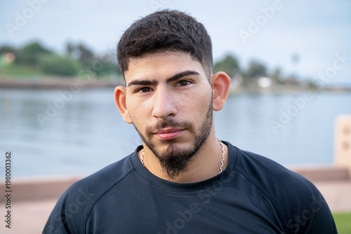 Quadro su tela Young man athlete portrait looking at camera outdoor