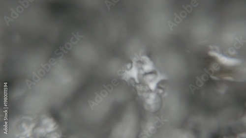 Underwater POV of fresh water flowing from a fountain tap with bubbles.
