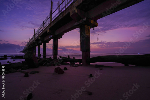 Purple twilight over beach pier.