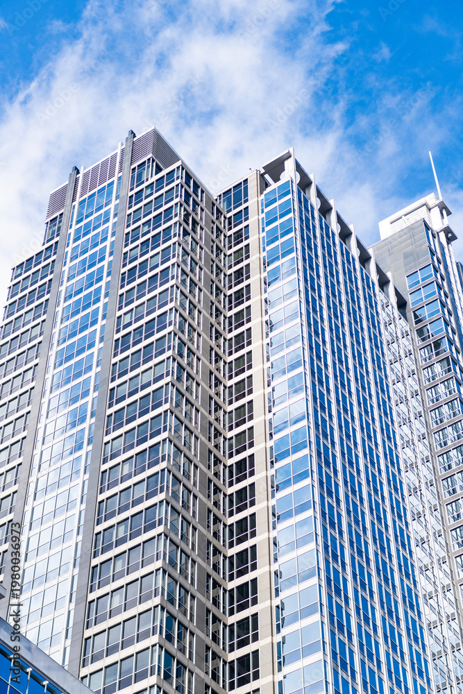 Fototapeta premium Business city. City architecture. Modern glass building. Reflective glass architecture. Architecture business district. Building architecture. Business building. Glass building. Urban business core
