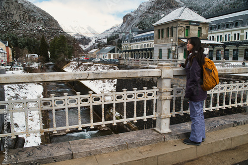 A girl walking at the Canfranc International Station, covered in snow, in the Aragonese Pyrenees; it opened in 1928 in Huesca, Spain, on the border with France.