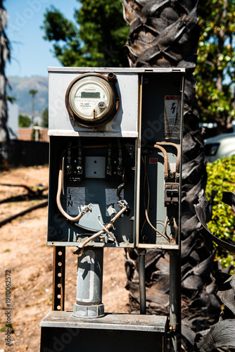 Outdoor electrical meter box with exposed wiring and a digital display