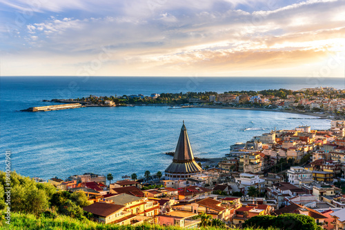 seascape panorama of mediterranean coast landscape with old italian town in golden sunset sun rays and beautiful evening blue sea gulf