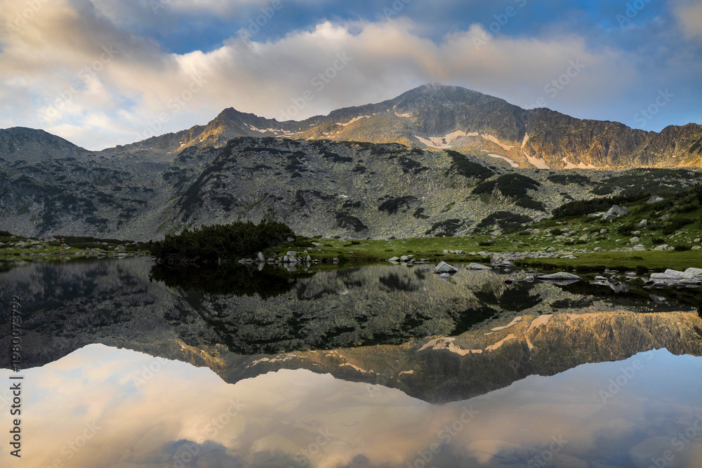 Fototapeta premium Reflection of rocky peak in the calm water in Pirin mountain. National park in Bulgaria.